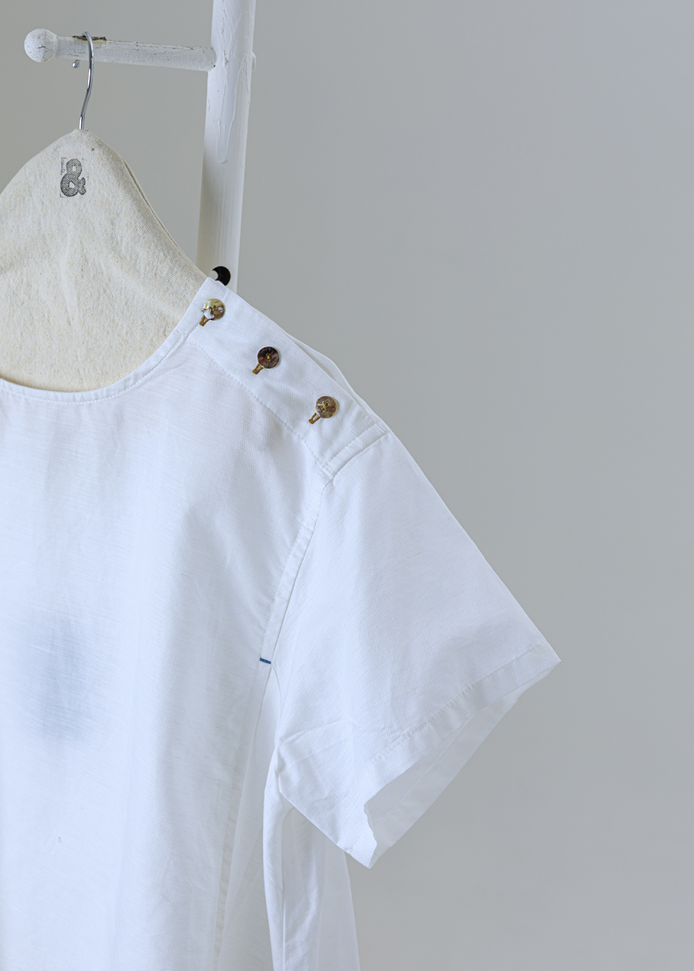 點金肩飾釦斜裁短袖上衣