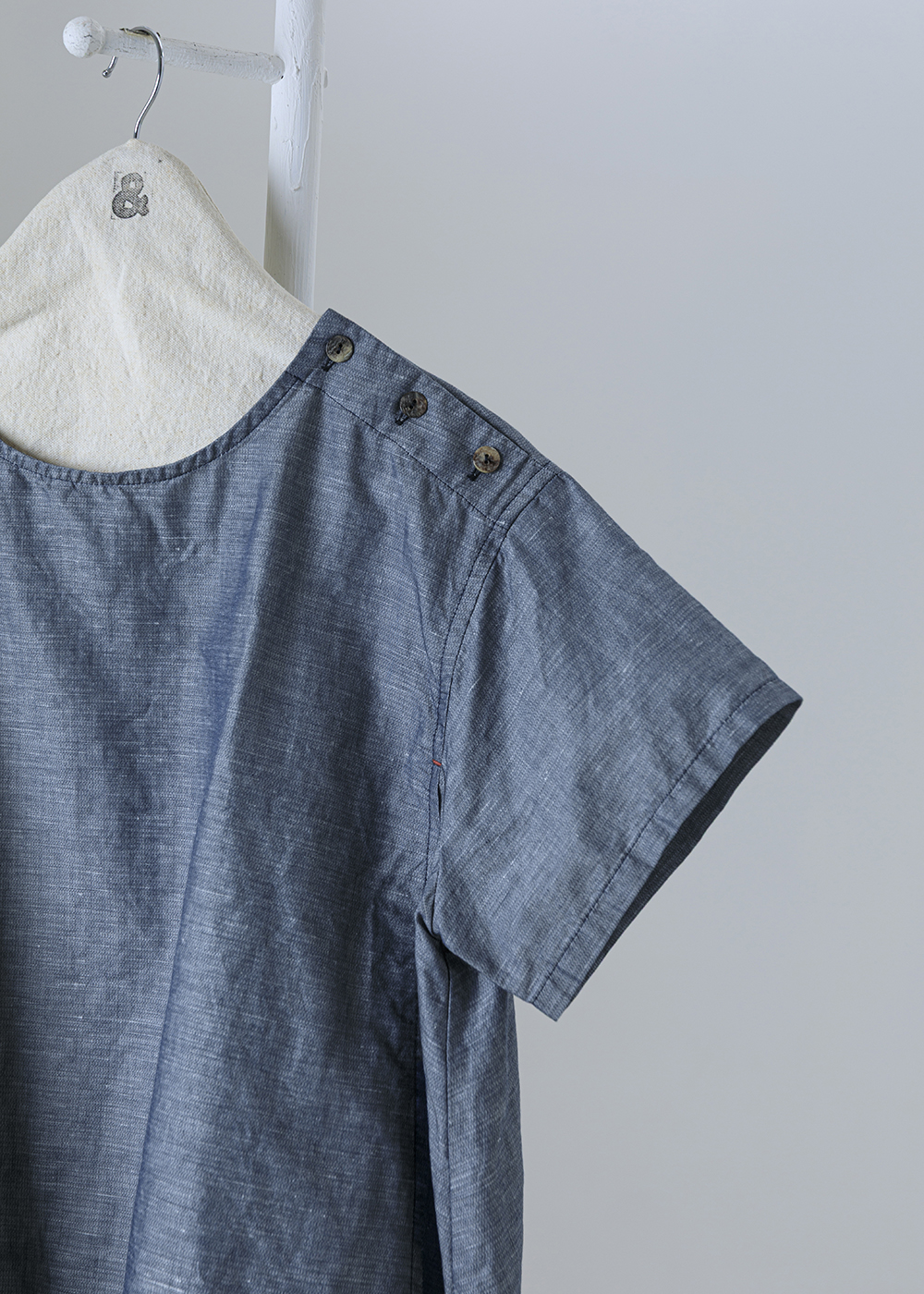 點金肩飾釦斜裁短袖上衣