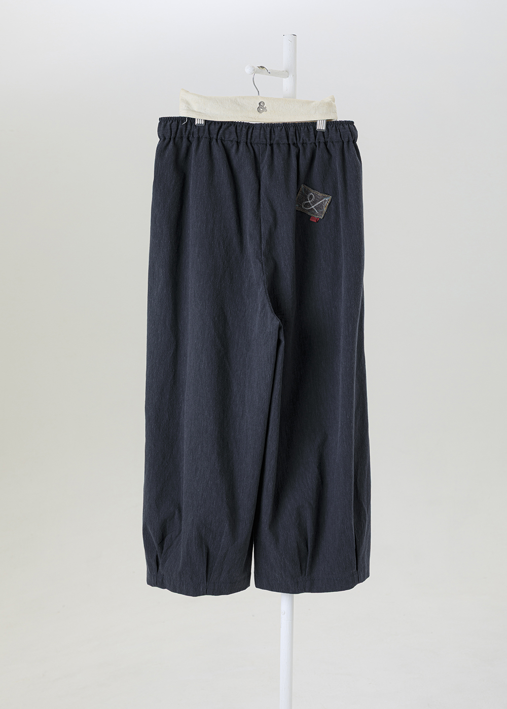 謐境下擺打褶繭型褲 